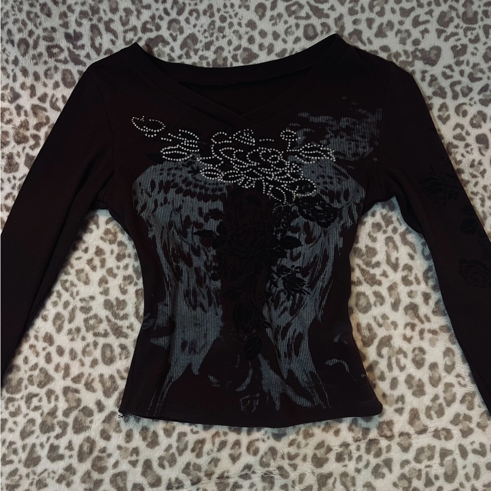 dark brown tight fitted long sleeve top with a rhinestone embroidery